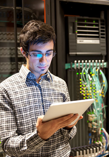 Information Technology professional in front of server