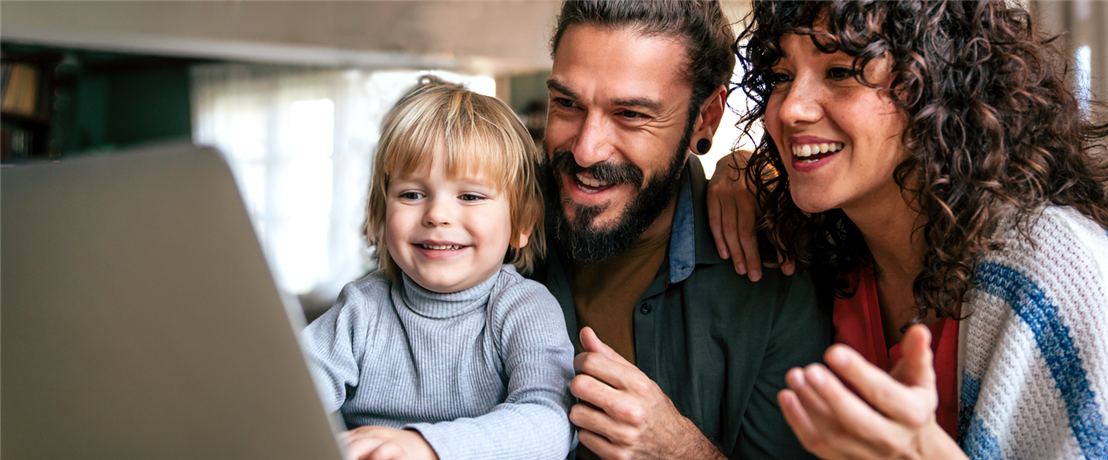 Man, woman, and child looking at laptop.