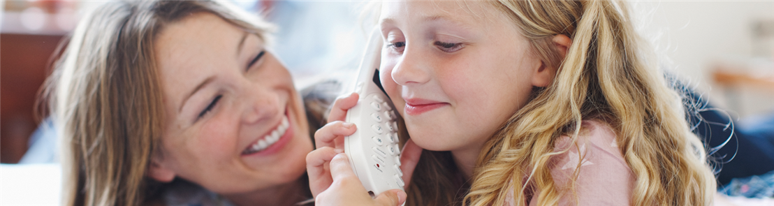 Mother and daughter talking on landline