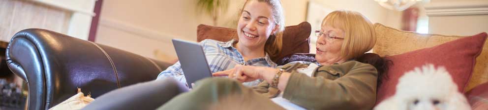  Grandmother and granddaughter watching video on a tablet