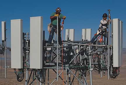 Two men on top of cell tower